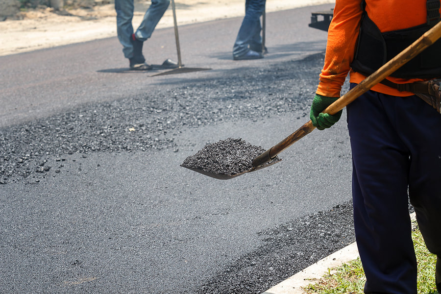 workers repairing drivers using asphalt